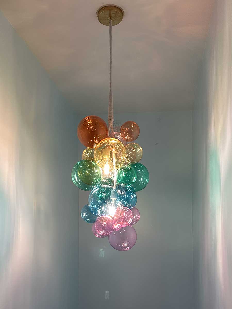 Back staircase chandelier from Westchester County NY interior design project by The Red Shutters