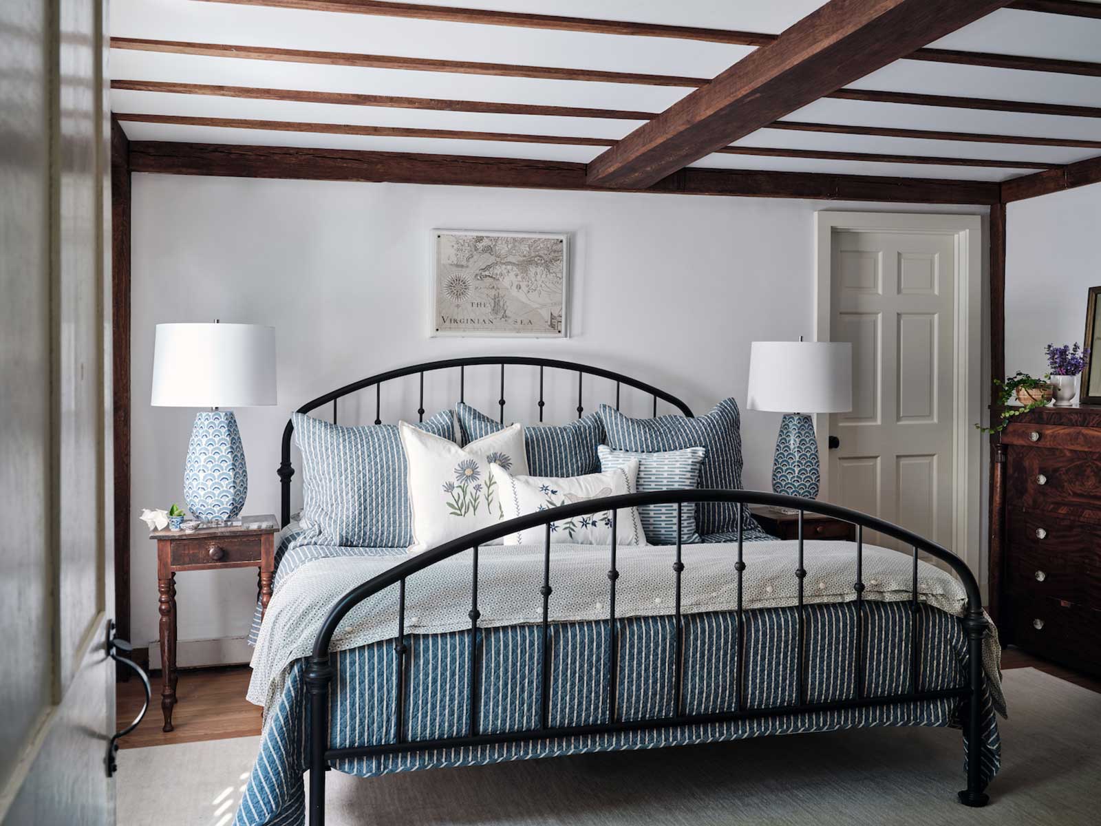 Primary-Bedroom-Styled-with-Iron-Bed-with-Blue-and-White-Bedding-and-Lamps