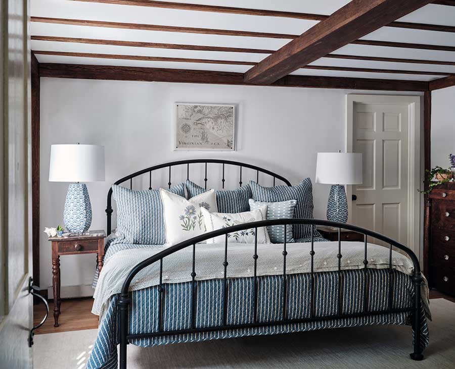 Primary-Bedroom-Styled-with-Iron-Bed-with-Blue-and-White-Bedding-and-Lamps