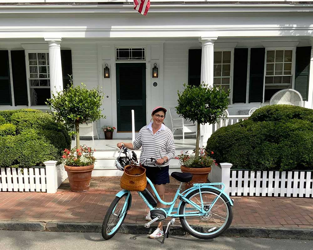 Interior Designer Marina Case Standing Next to a Bicycle with a Nantucket Basket