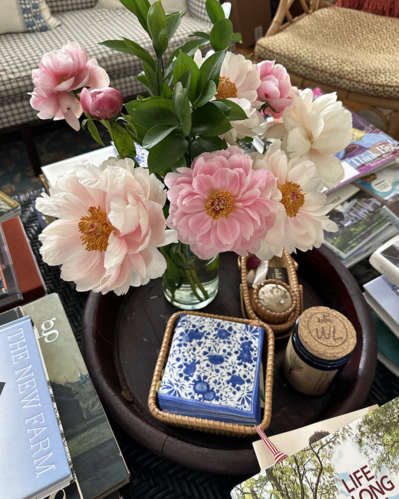 Several Nantucket Baskets on a Coffee Table Tray with Flowers